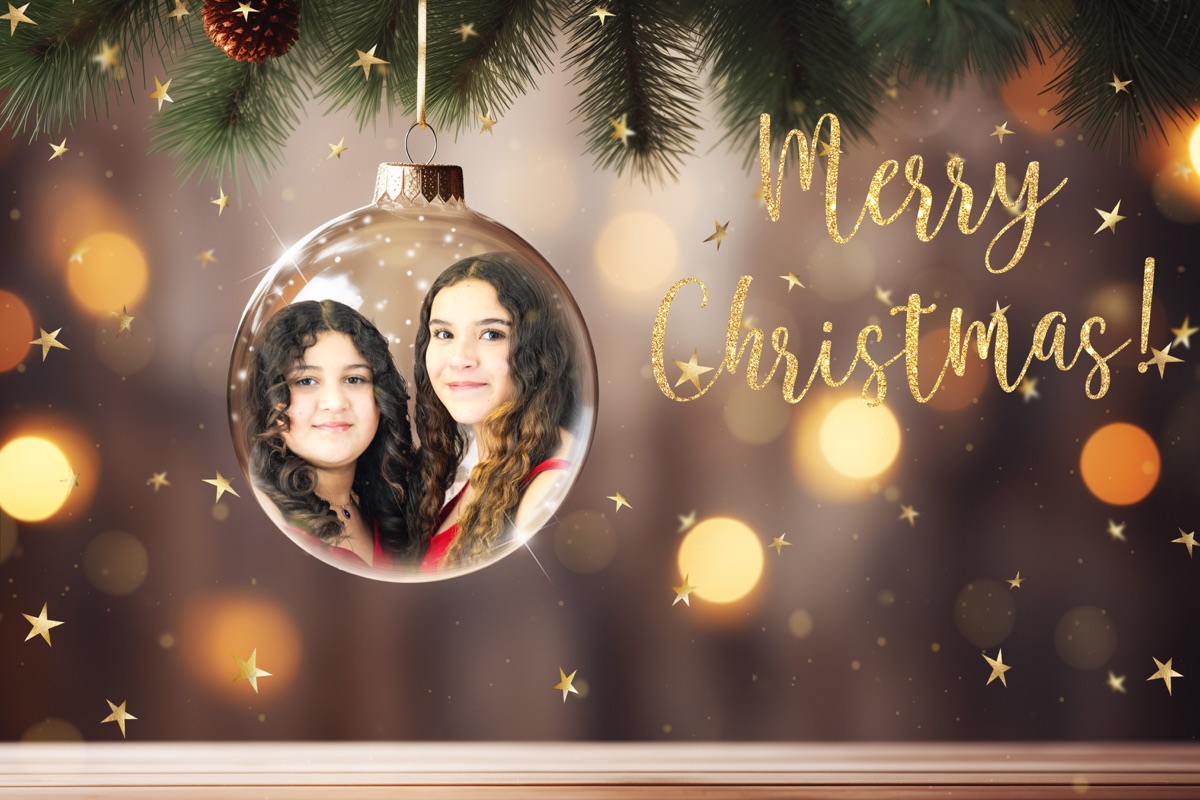Creative Christmas portrait of two girls inside a glass ornament