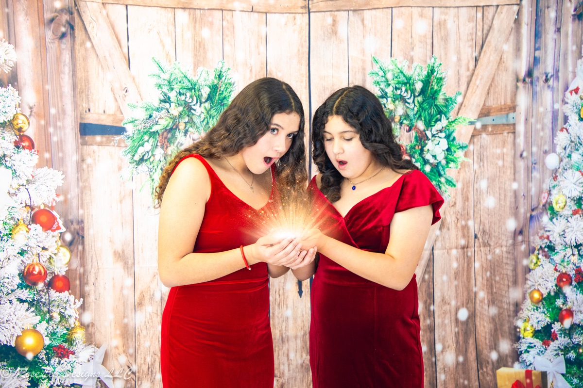 Two young women sharing a moment in a festive studio scene