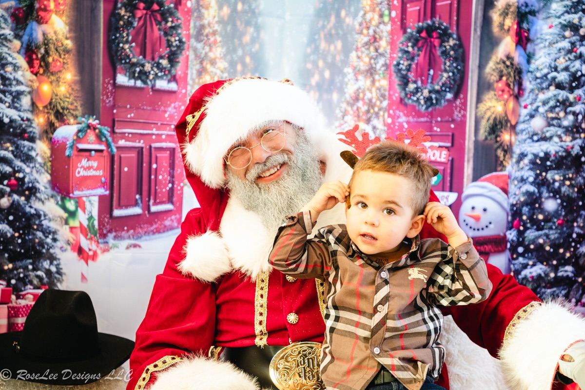 Santa holding a young child in a Christmas portrait