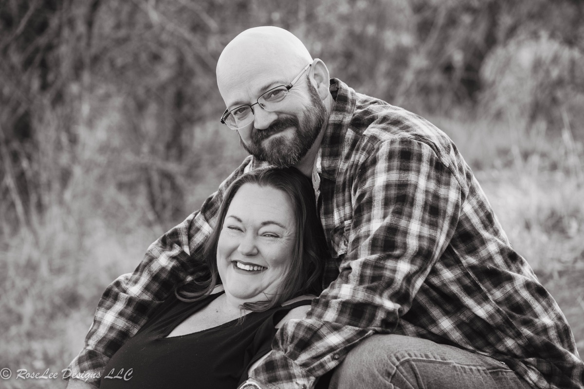 Couple embracing and laughing in black and white