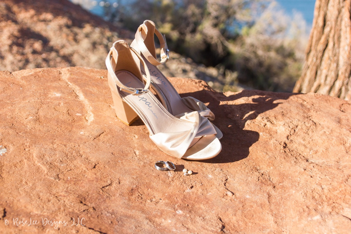 Wedding shoes resting on sunlit red sandstone