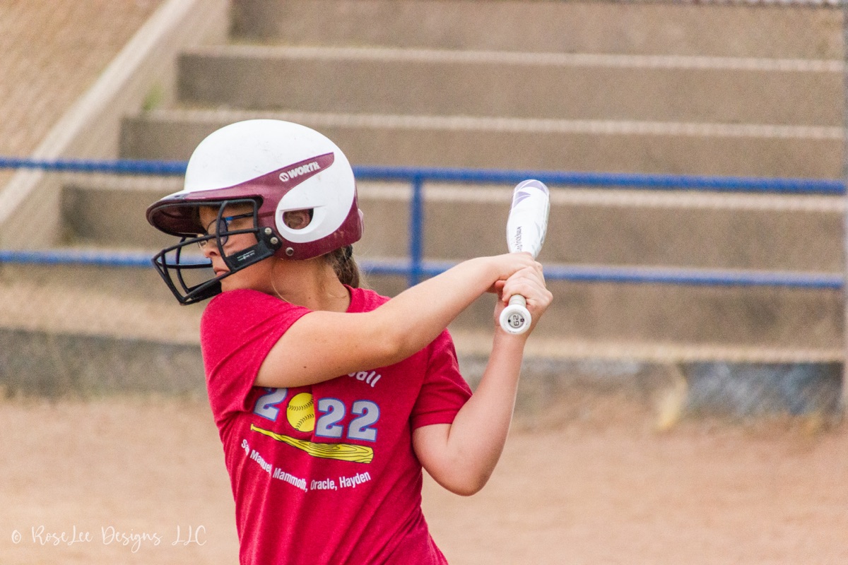 Softball player preparing to swing her bat