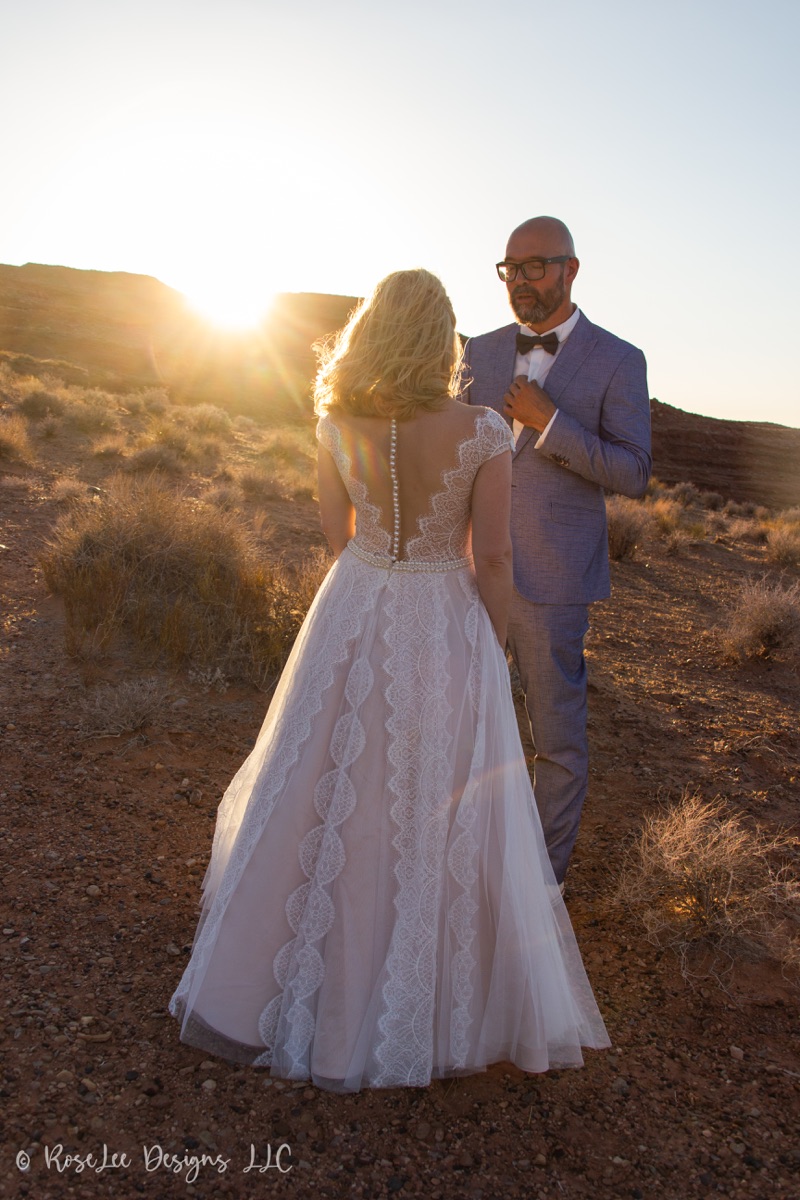 Bride and groom embracing in soft sunset backlight