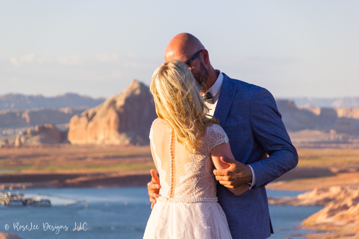 Close wedding portrait of a couple sharing a kiss