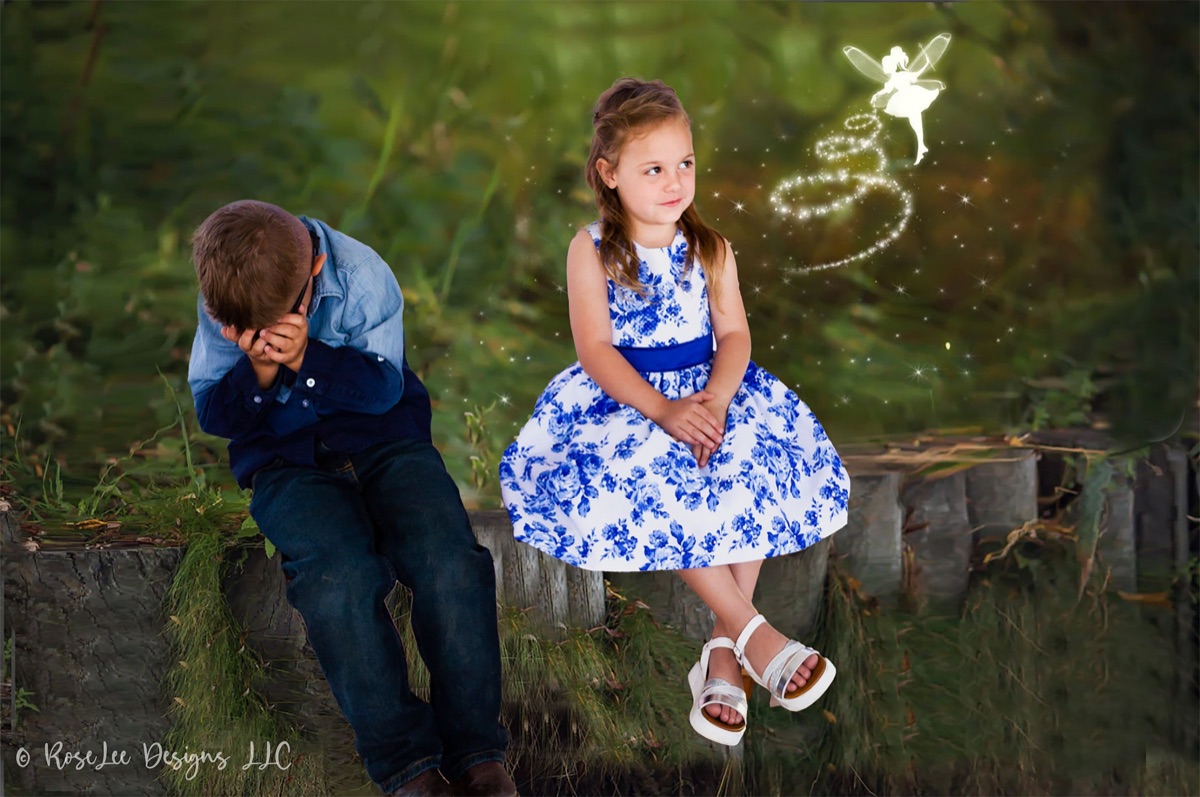 Creative woodland portrait of children with a glowing fairy