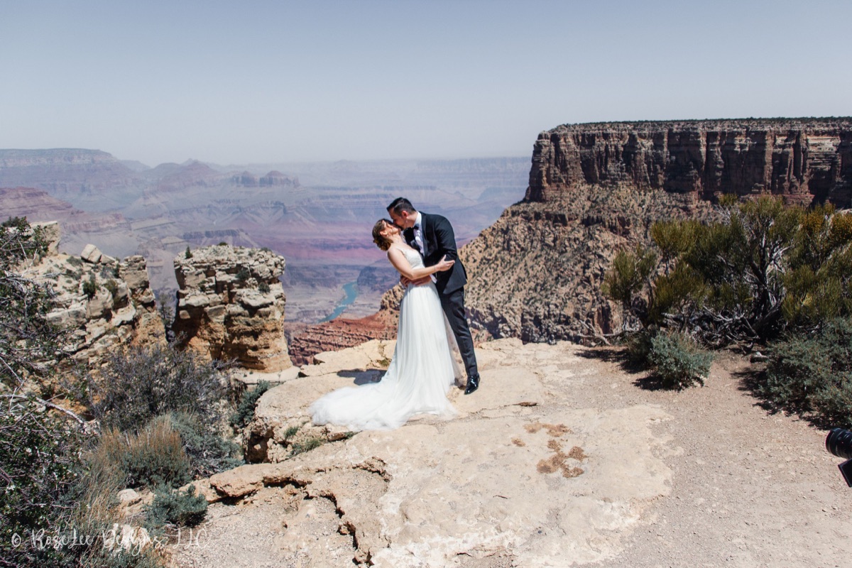 Newlyweds embracing beside the Grand Canyon